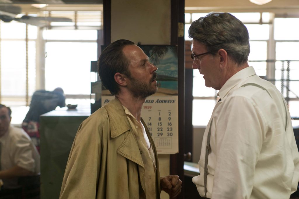 Cinematic film still The Rum Diary Giovanni Ribisi as Moberg in trench coat 1959 office scene Wallpaper