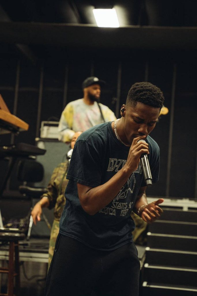 Giveon singing in studio wearing vintage Led Zeppelin shirt soulful R&B rehearsal wallpaper