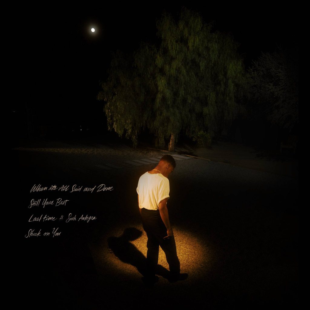 Giveon illuminated in warm light under full moon moody night sky cinematic wallpaper background