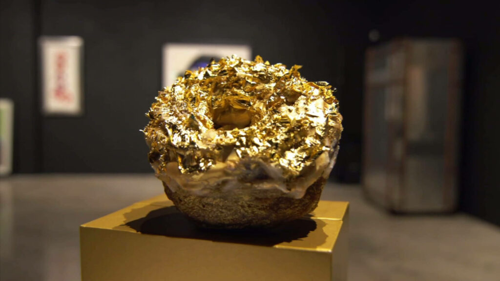 Luxury Sweet Delight: Exquisite Golden Foil-Adorned Donut Captured in Stunning Detail Wallpaper
