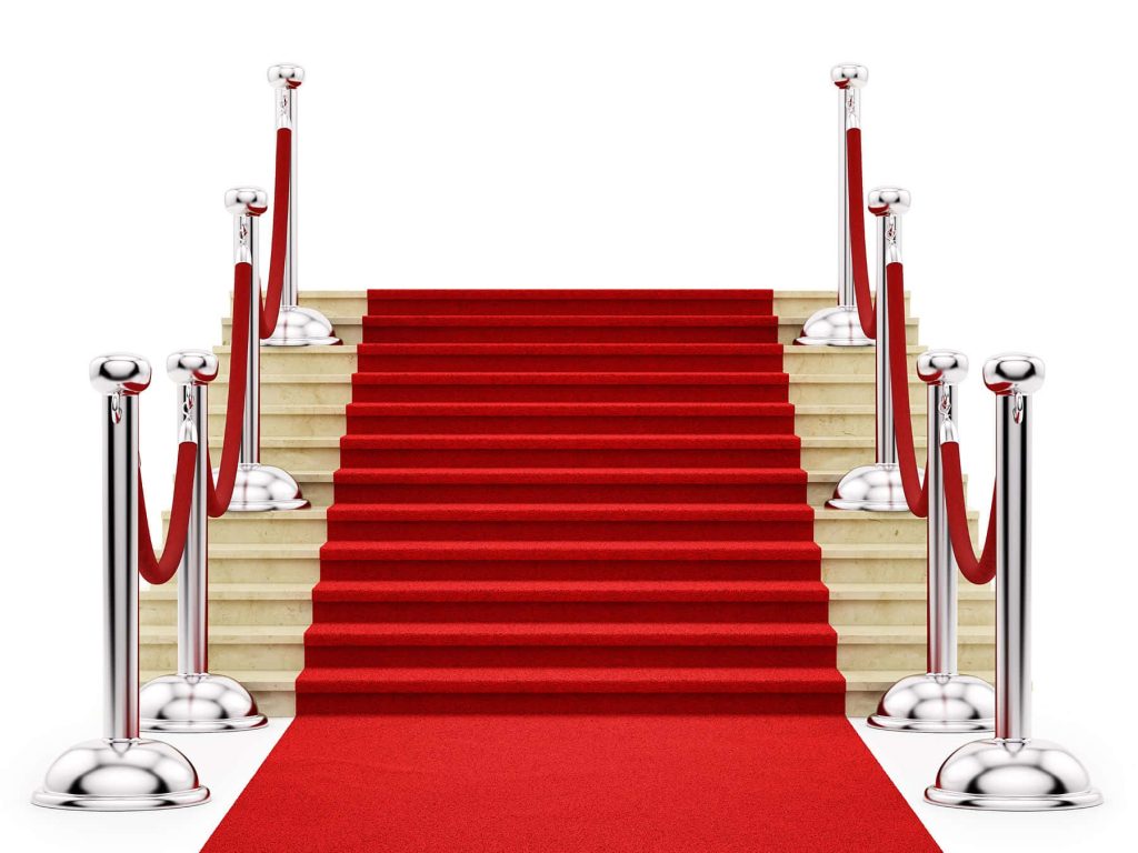Glamorous red carpet staircase with chrome stanchions and velvet ropes VIP entrance wallpaper