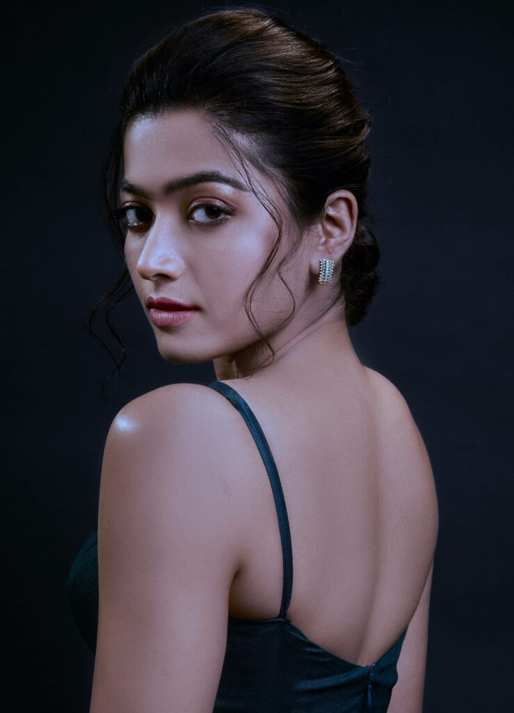 Captivating Beauty: Rashmika Mandanna radiates elegance in mesmerizing makeup on a dark backdrop Wallpaper