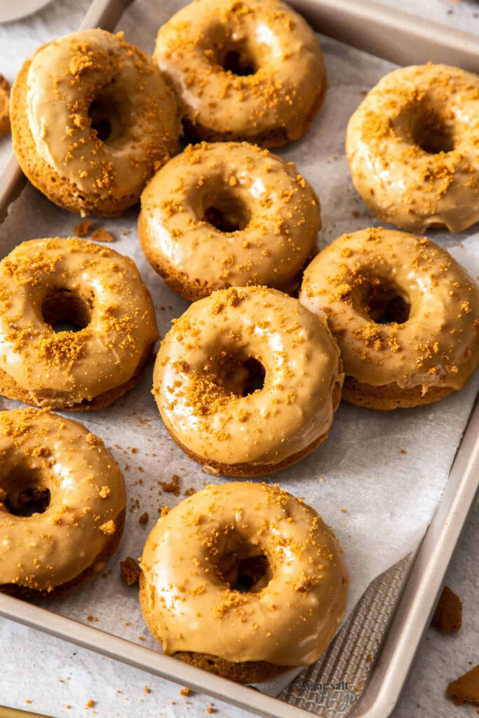 Tray of caramel glazed donuts with crumbly topping warm inviting food photography wallpaper