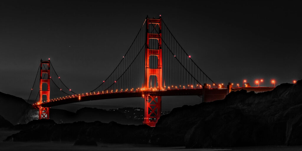 The Majestic Golden Gate Bridge Engulfed in a Mysterious Nightfall Wallpaper