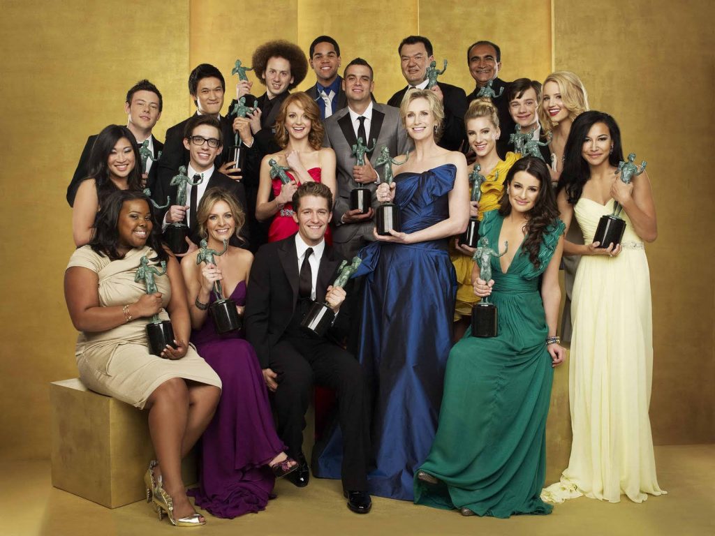 Glee cast 2010 SAG Awards group portrait holding golden statuettes elegant evening wear Wallpaper