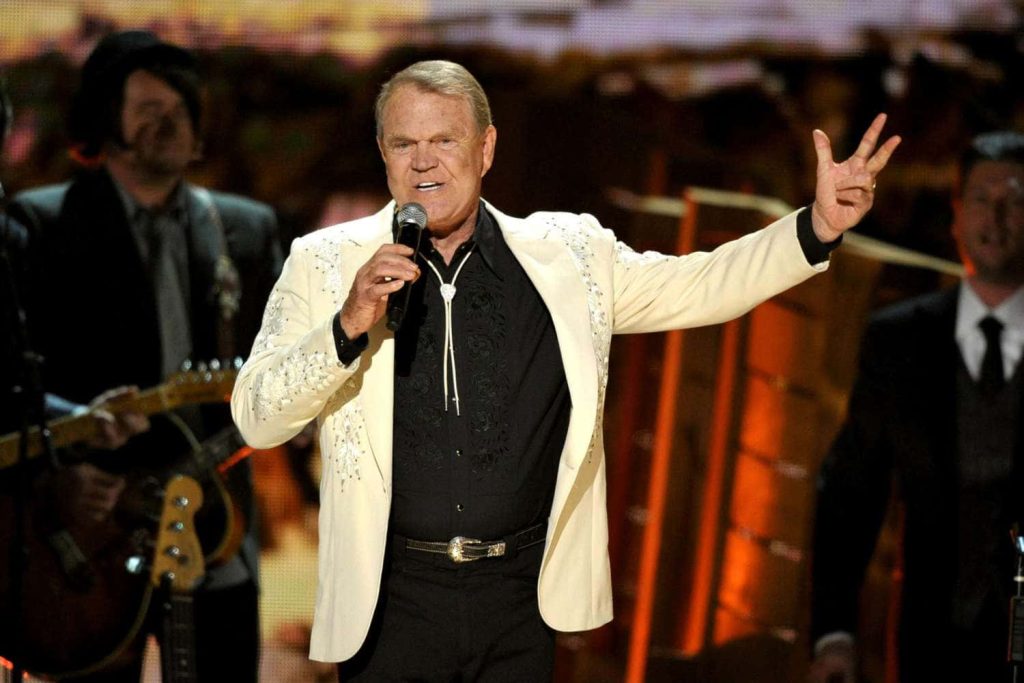 Glen Campbell live concert wallpaper golden lights white blazer bolo tie country music legend