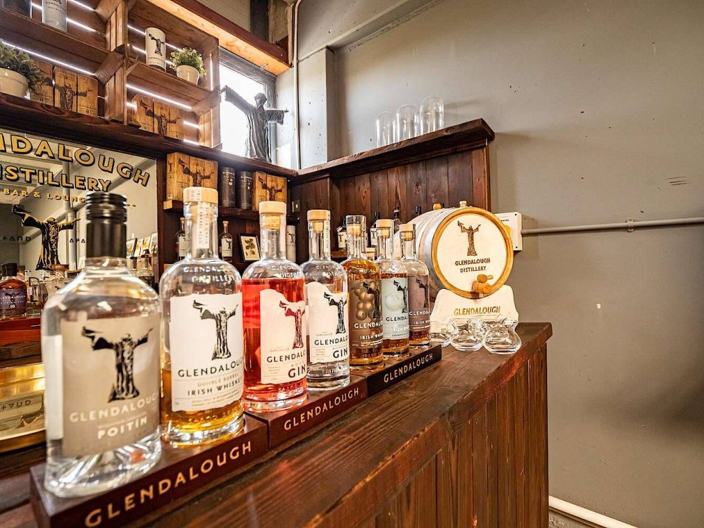 Glendalough Distillery Irish craft spirits display with poitin whiskey rose gin and wooden barrel Wallpaper