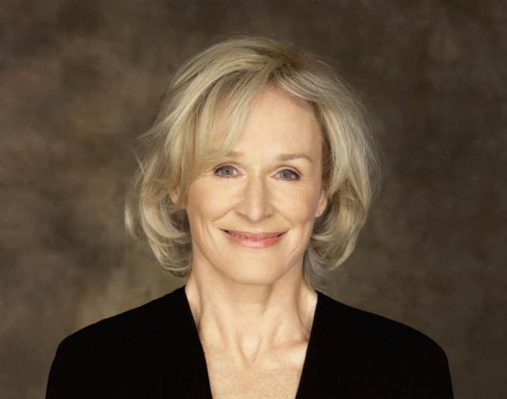 Glenn Close smiling professional studio portrait soft lighting classic style neutral backdrop Wallpaper