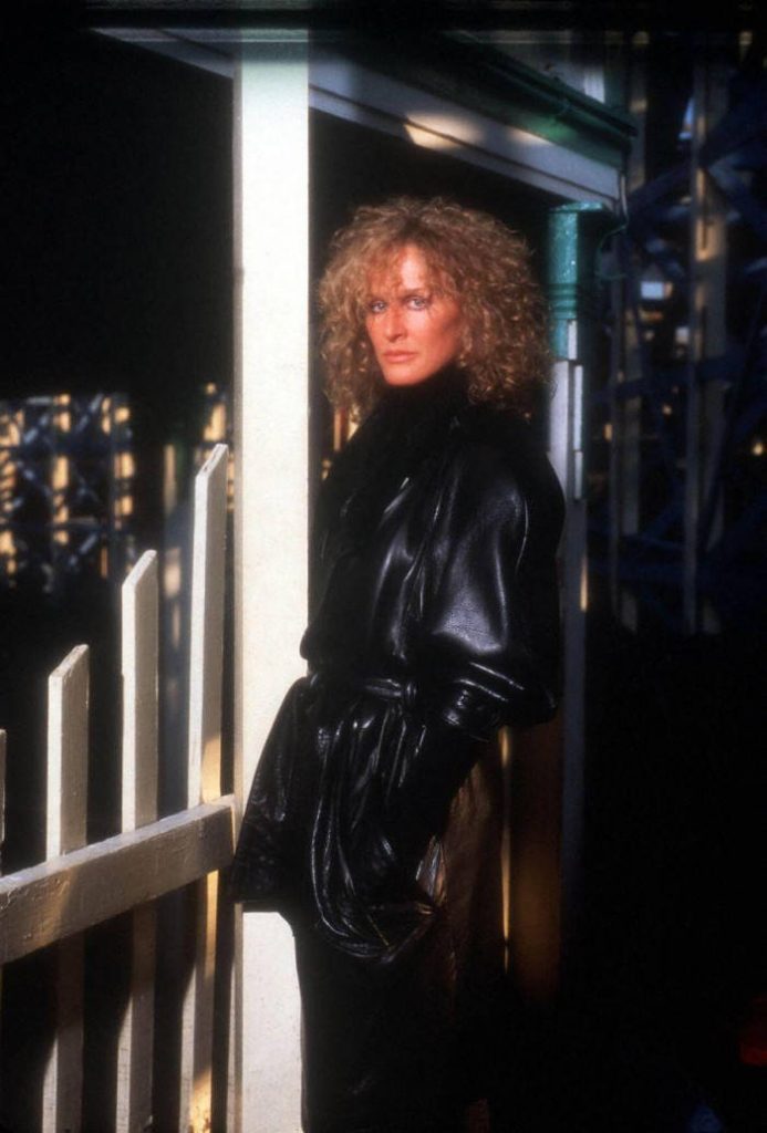Glenn Close as Alex Forrest intense gaze black coat dark moody background Fatal Attraction iconic shot Wallpaper