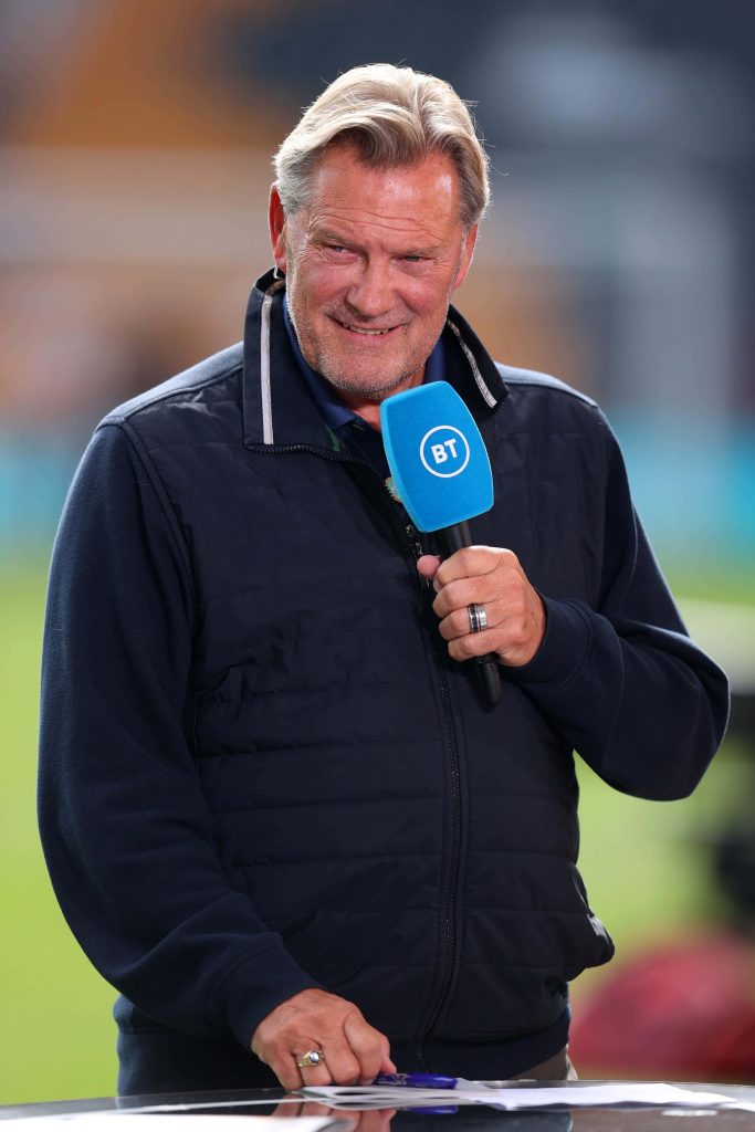 Glenn Hoddle smiling with BT Sport mic in navy jacket stadium background sports wallpaper