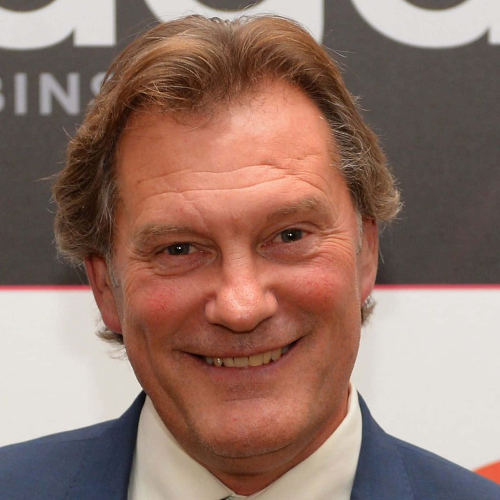 Glenn Hoddle smiling in blue suit high resolution portrait English football legend wallpaper background