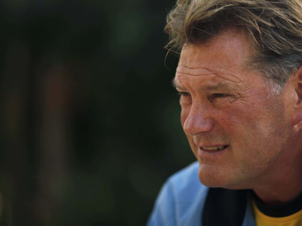 Close-up profile of English football legend Glenn Hoddle in blue yellow shirt with dark background Wallpaper