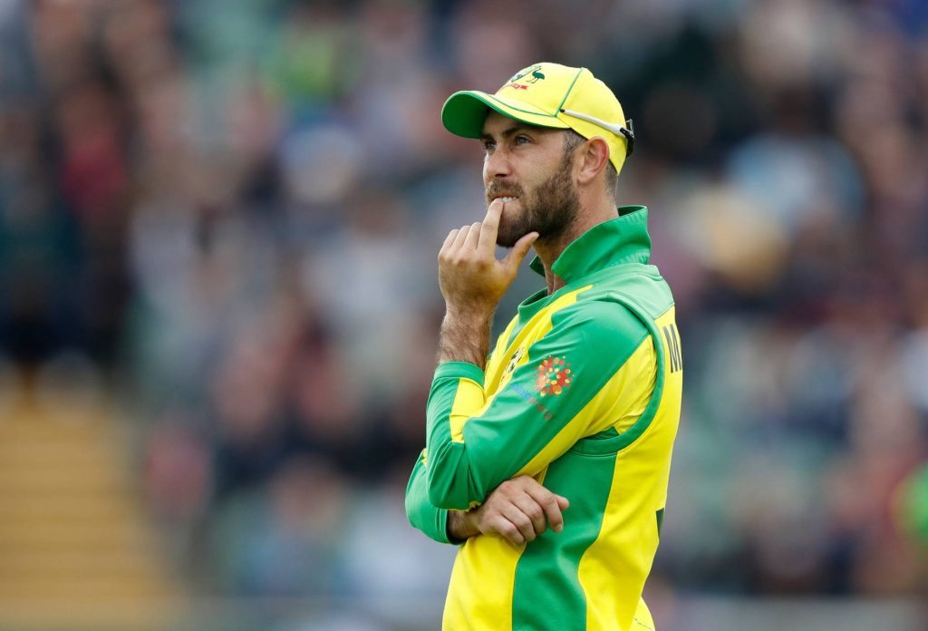 Glenn Maxwell in yellow green kit focused on field Australian cricket star wallpaper background