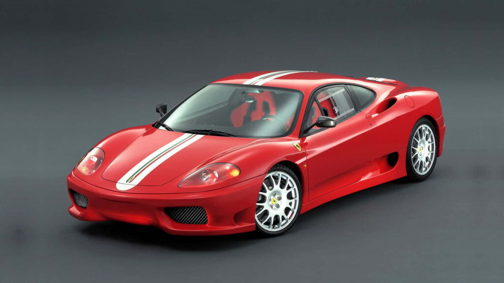 Exquisite Performance: Capturing the charismatic allure of a red Ferrari 360 Modena racing through picturesque streets Wallpaper