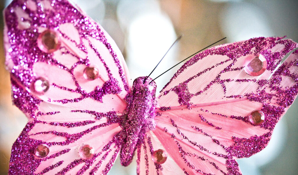 Sparkling Pink Butterfly: A Delightful Glittery Gem-Adorned Background Wallpaper
