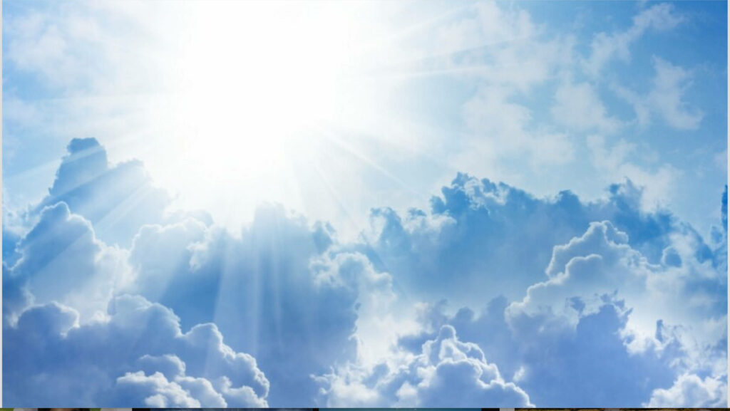 Radiant sunbeams shining through white clouds in bright blue sky serene inspiring wallpaper background