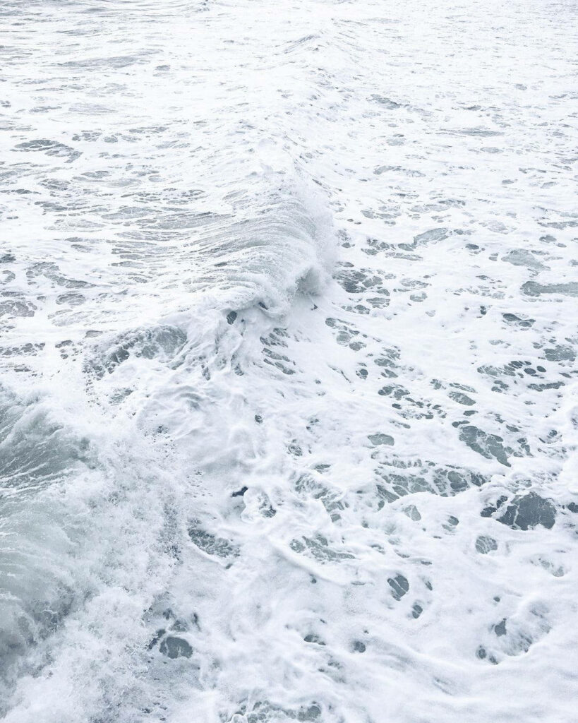 Mesmerizing Marine Beauty: Captivating Oceanic Majesty with Glistening Sea Foam - Perfect White Background for Your Phone Wallpaper