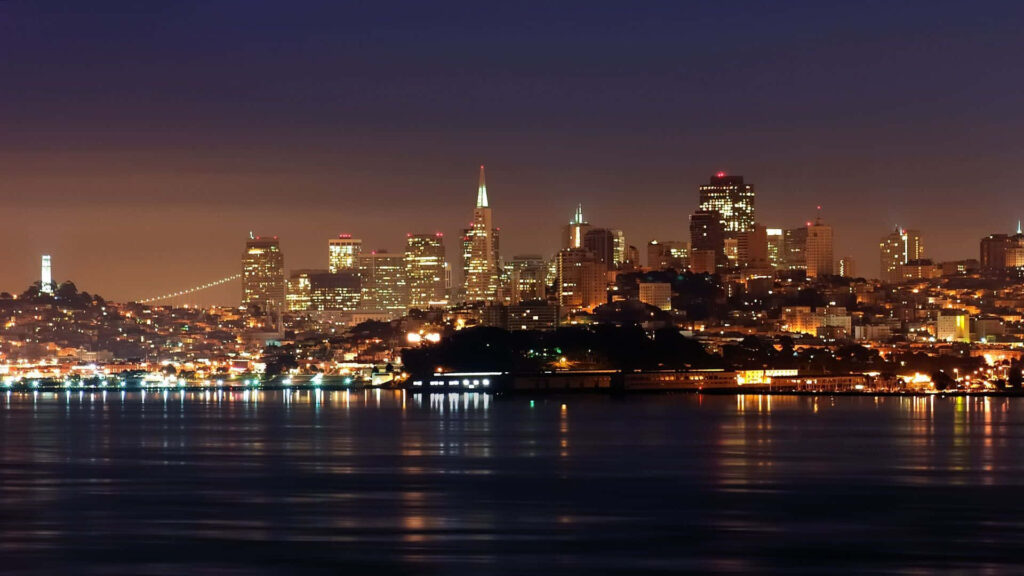 Enchanting Nighttime Vista of San Francisco's Cityscape: An Awe-Inspiring Laptop Background Wallpaper