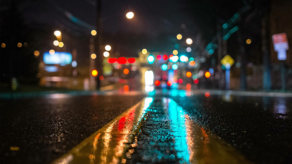 Nighttime Reflection: Bokeh Illusions on a Rain-soaked Road - Captivating 4K PC Background Wallpaper