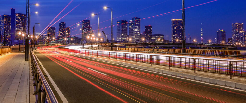 Blurring Through the Night: Long Exposure Road Lights in the Ultrawide Cityscape with Architectural Background Wallpaper