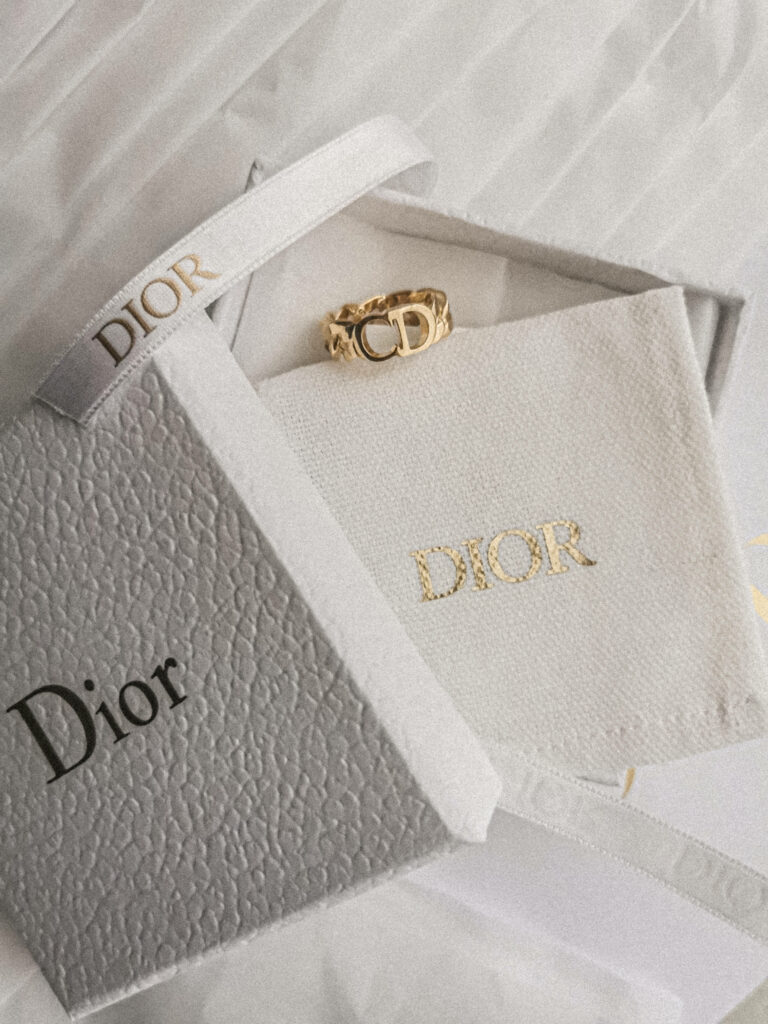 Gilded Elegance: Captivating Dior Gold Ring and Gift Box Wallpaper