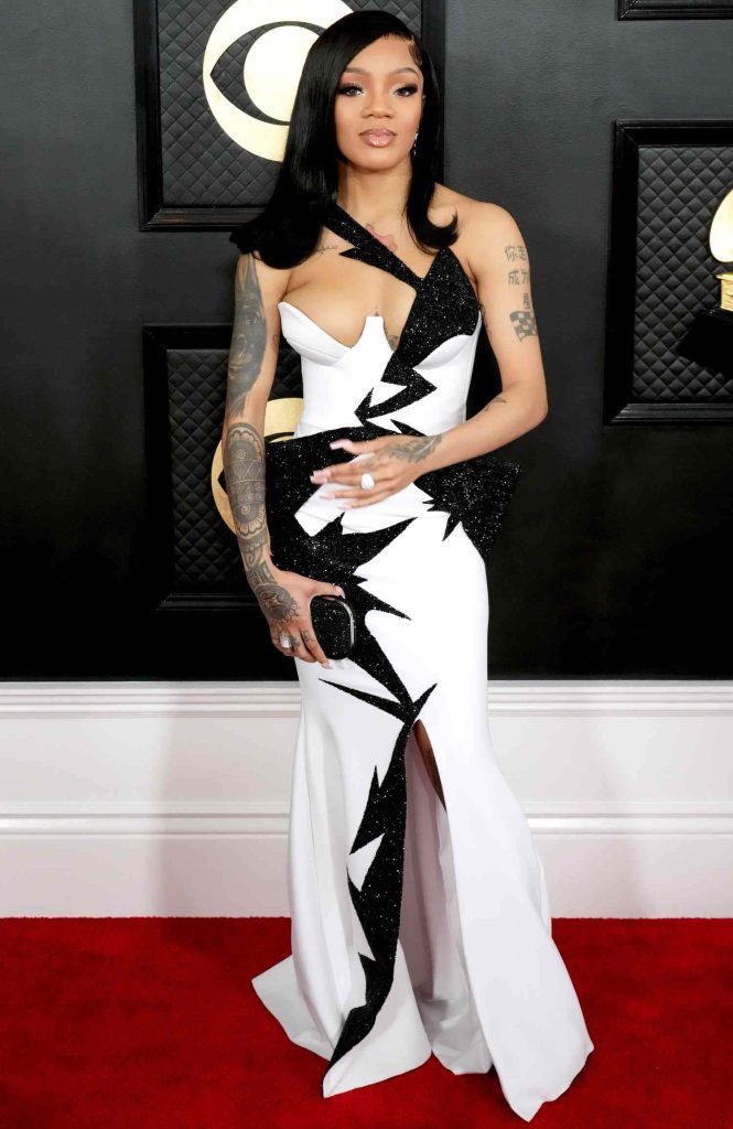GloRilla in black and white gown with tattoos on Grammy Awards red carpet wallpaper background