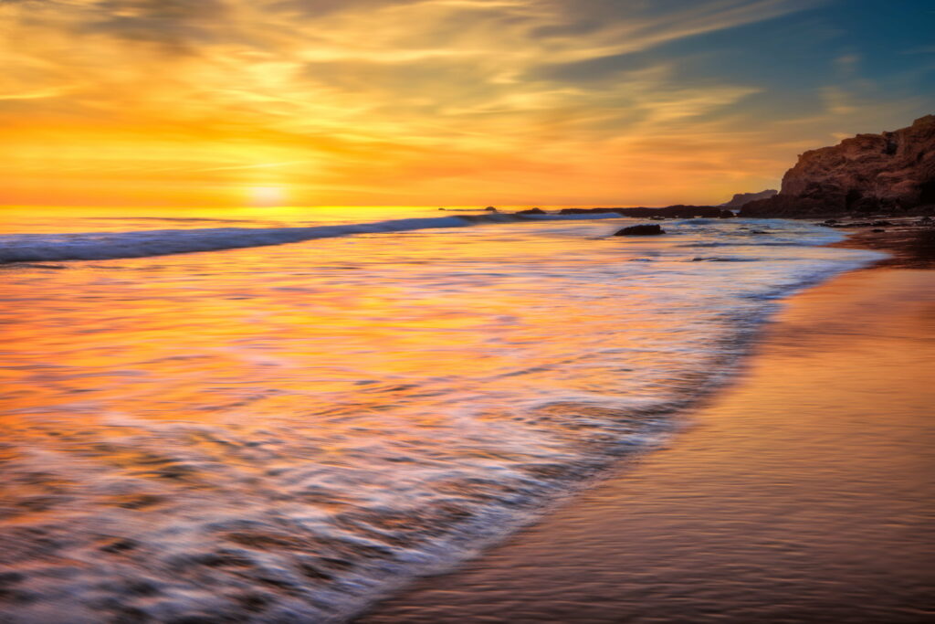 Golden Waves: Capturing the Serenity of a Long-Exposure California Ocean at Sunrise. Wallpaper
