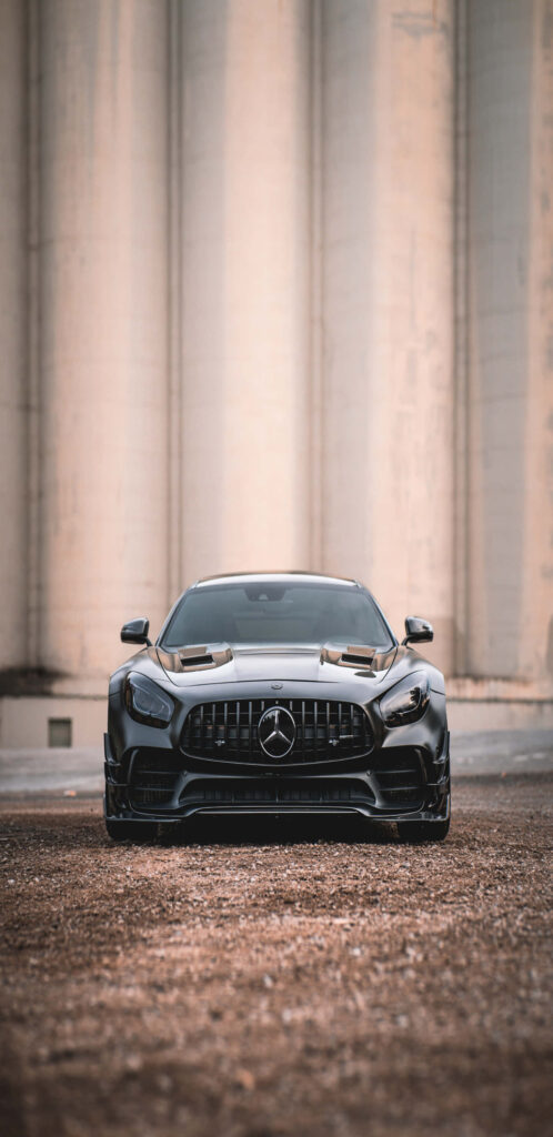 Glossy black Mercedes-Benz AMG GT-R front view showcasing aggressive grille and sleek design Wallpaper