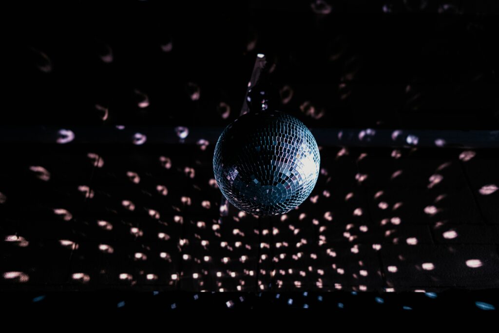 Glossy Disco Ball Wallpaper: Mesmerizing Light Reflections in Darkness