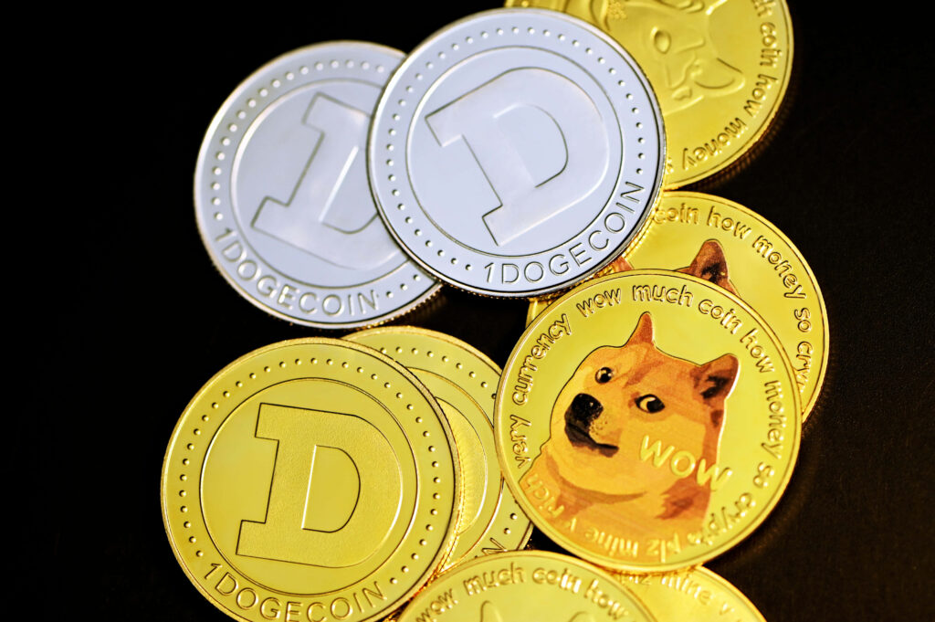 Glossy gold and silver Dogecoin tokens with Shiba Inu dog and wow text crypto wallpaper close-up