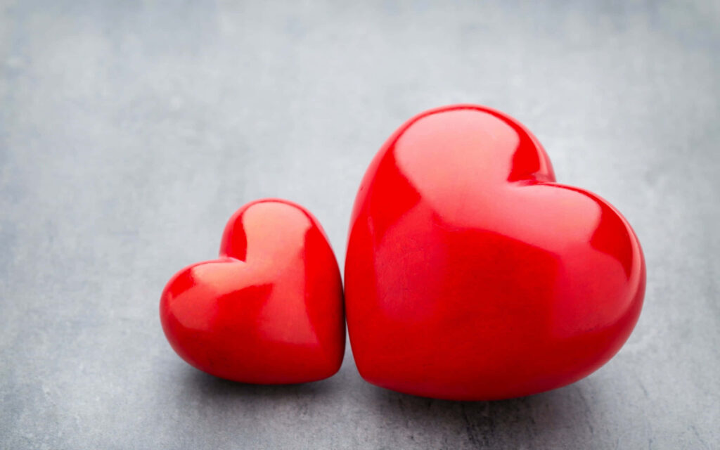 Vibrant Red Hearts Wallpaper on Soft Gray - Symbol of Love