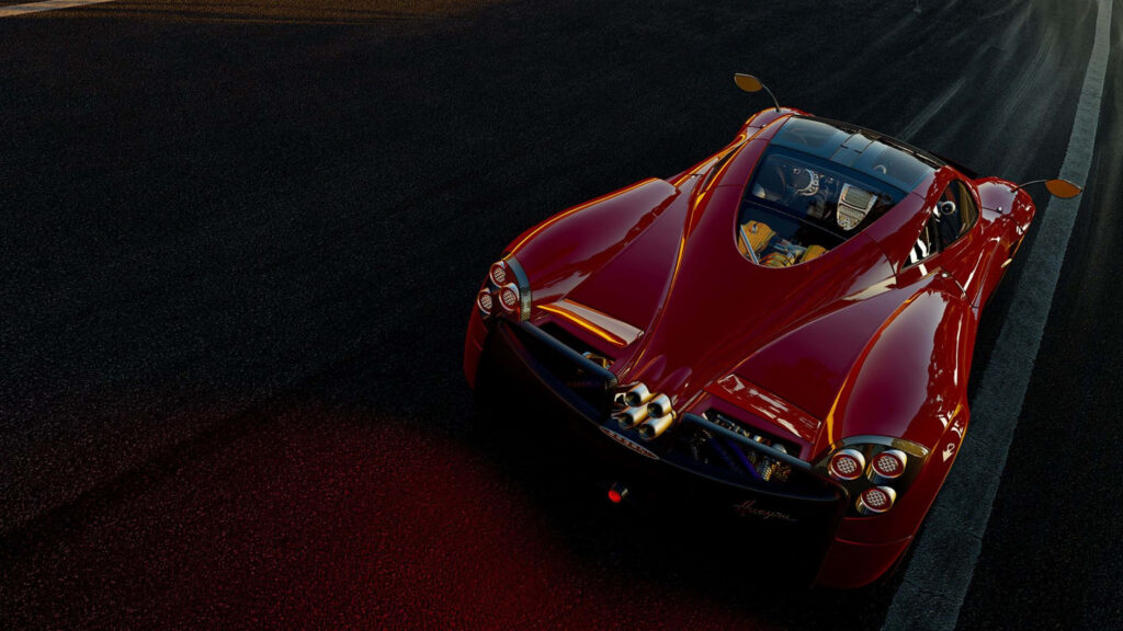 Glossy red Pagani Huayra 4k wallpaper on dimly lit racetrack showcasing sleek design