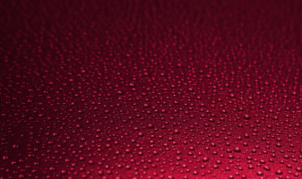 Glossy Red Textured Wallpaper with Scattered Water Droplets