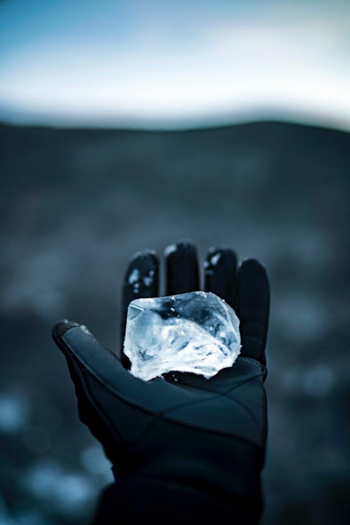 Gloved Hand Holding Ice: Stunning Winter Wallpaper Background