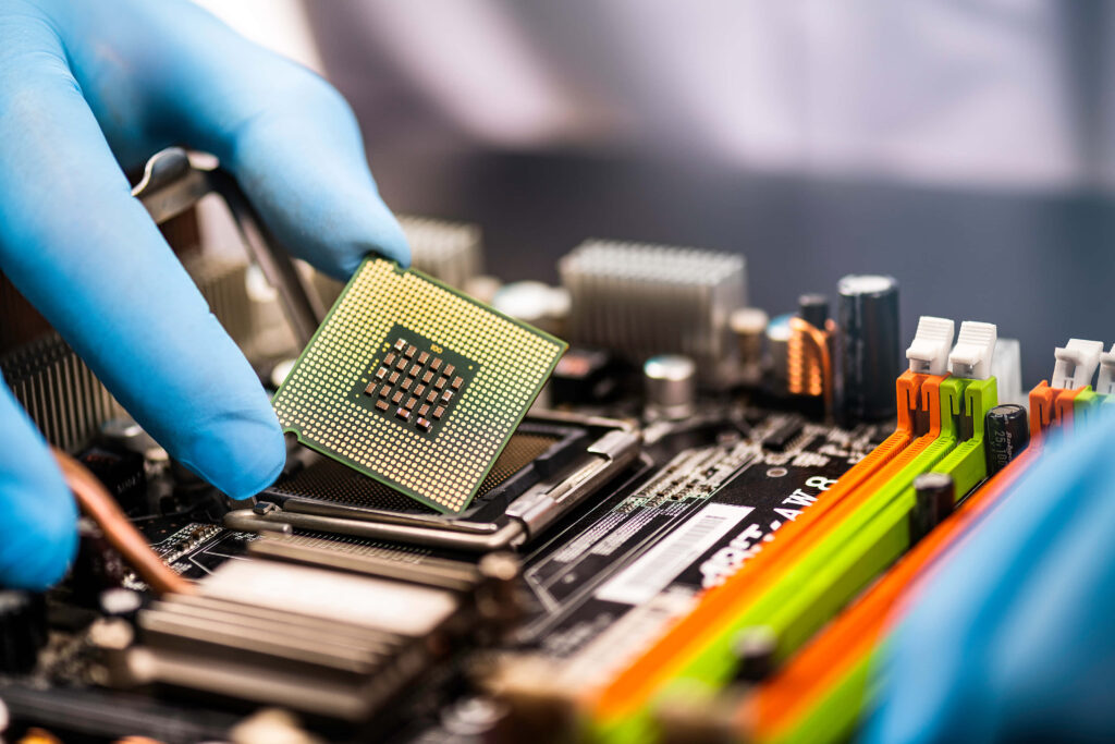 Gloved Hand Installing Processor Chip on Motherboard - Colorful Wallpaper