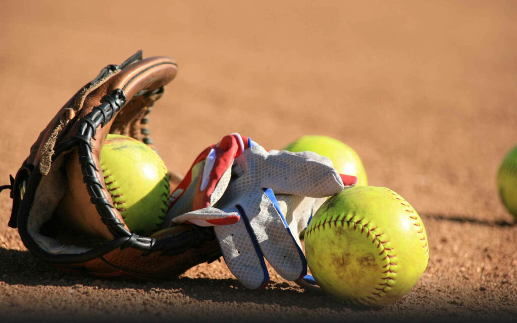 Playful Softball Scene: Adorable gloves and softballs on the field Wallpaper