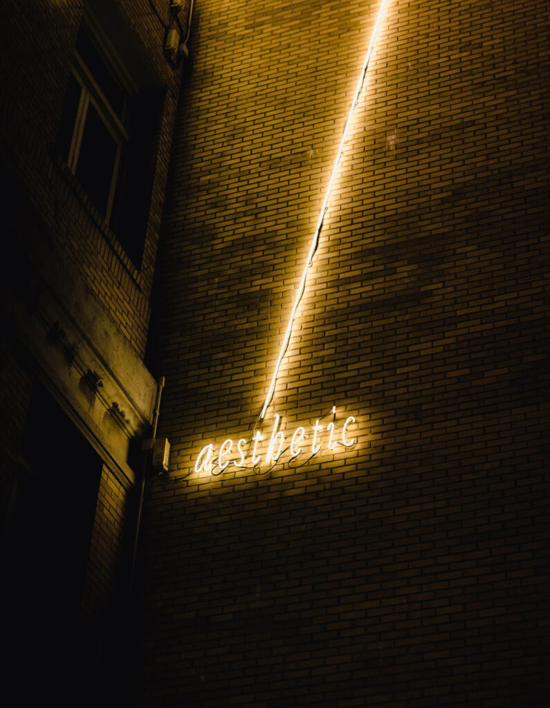 Glowing Words: Aesthetic Neon Inscription on Wall - HD Background for Phone Wallpaper