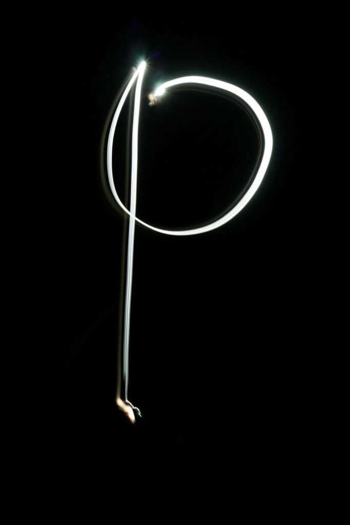 Artistic Glowing Letter P Wallpaper on Dark Background