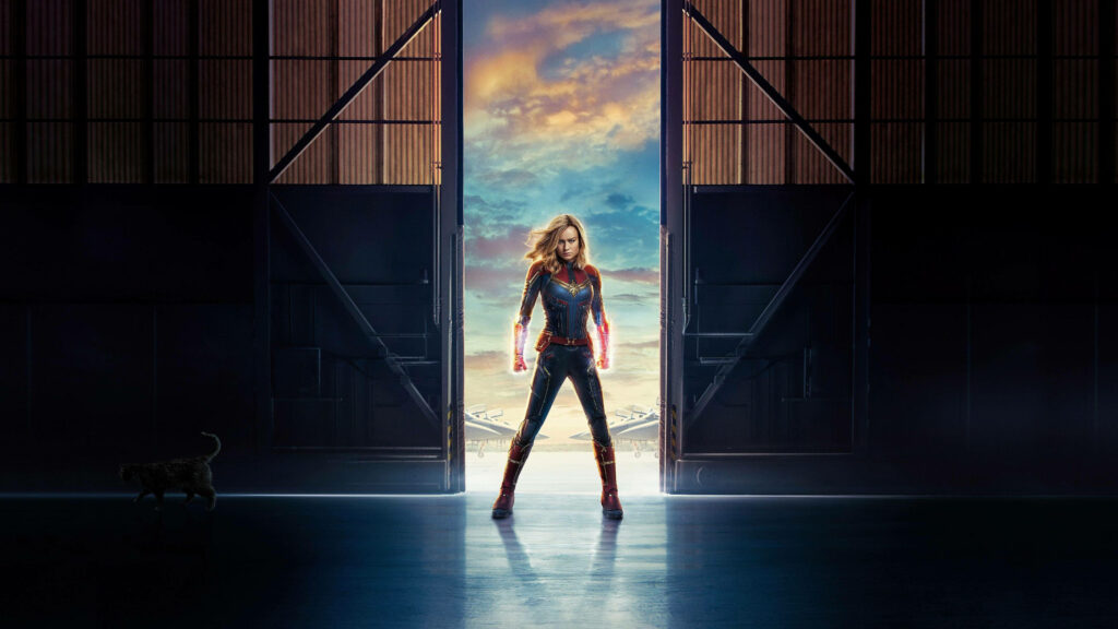 Glowing Empowerment: Captain Marvel's Vibrant Encounter Surrounded by Sliding Doors Wallpaper