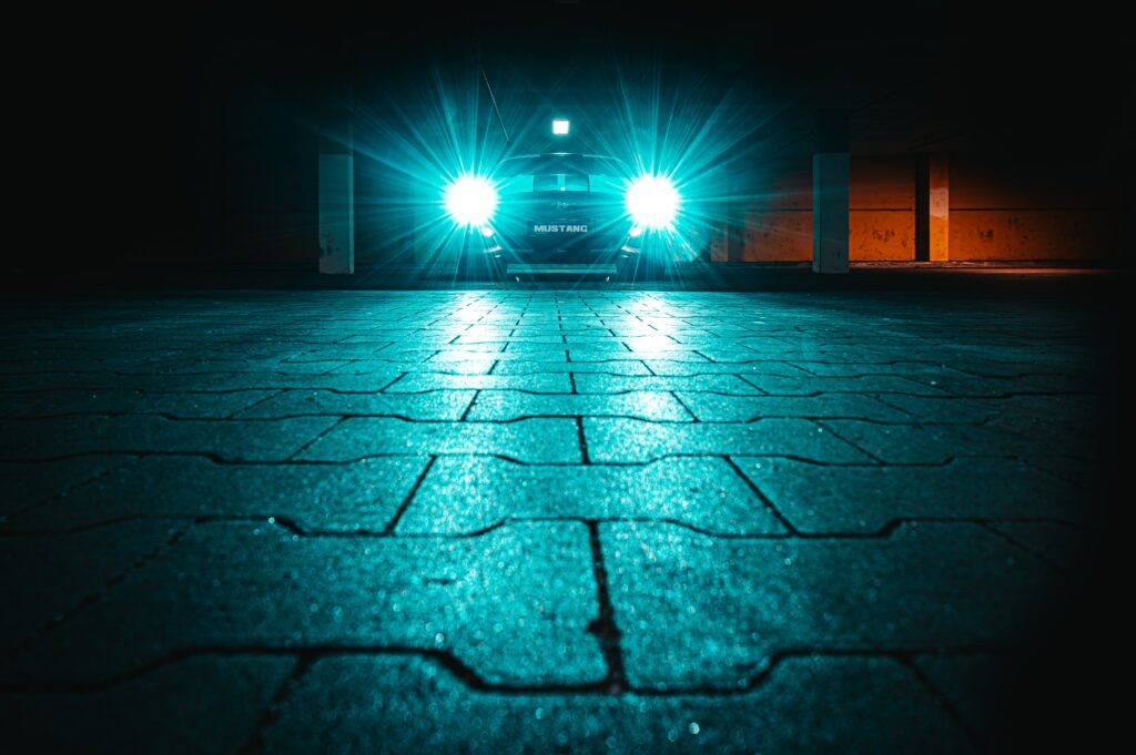 Nighttime Car Wallpaper: Glowing Headlights & Striking Contrast