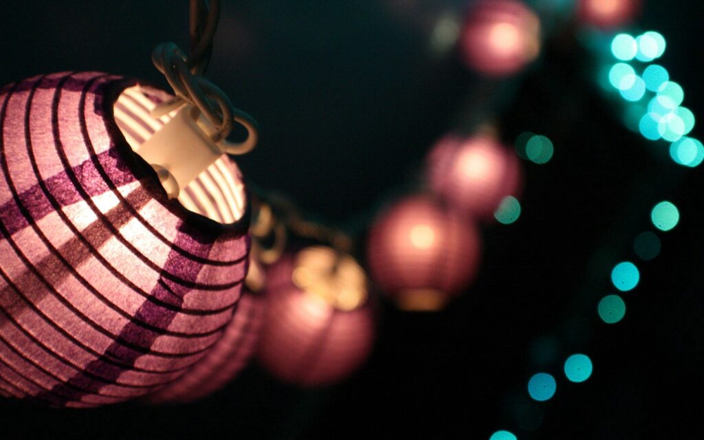 Elegant Lantern Wallpaper: Warm Glow with Teal Bokeh Background