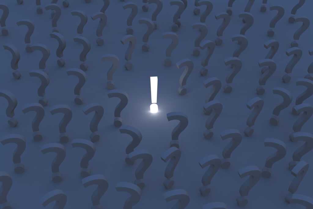Glow of Clarity: Exclamation Mark Amidst Question Marks Wallpaper