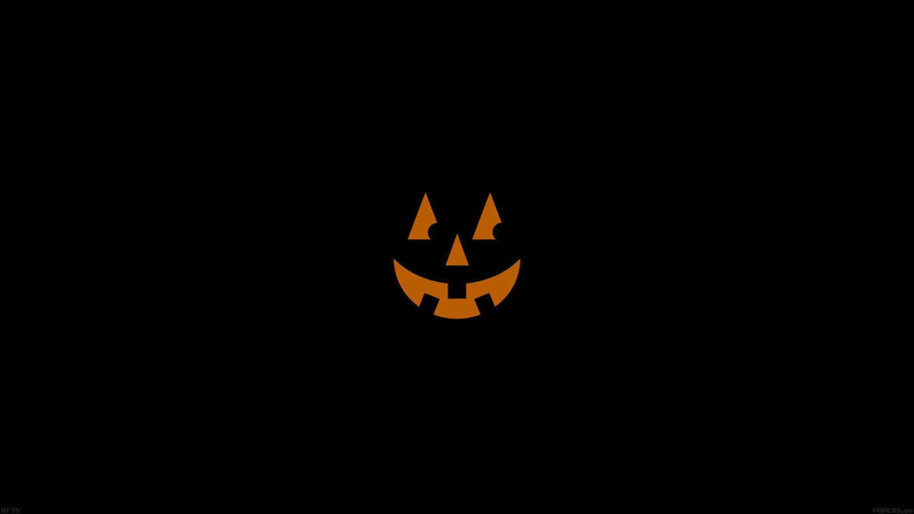 Glowing Grin: Spooktacular Halloween Laptop Background Wallpaper