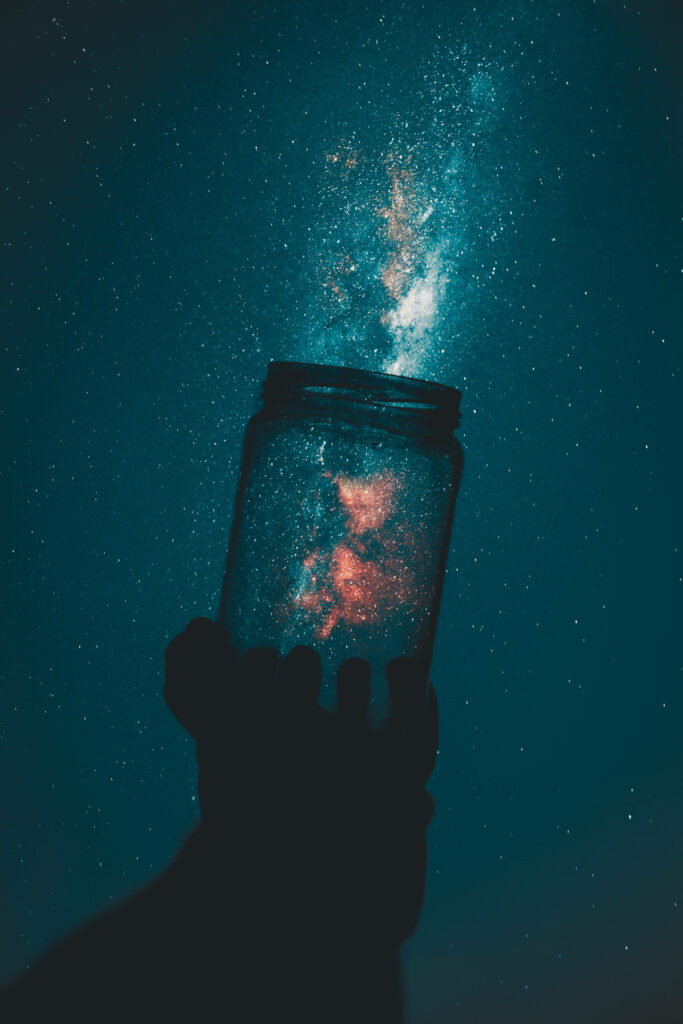 Silhouetted Hand Reaching Towards Fiery Milky Way: A Captivating Android Wallpaper for Night Owls