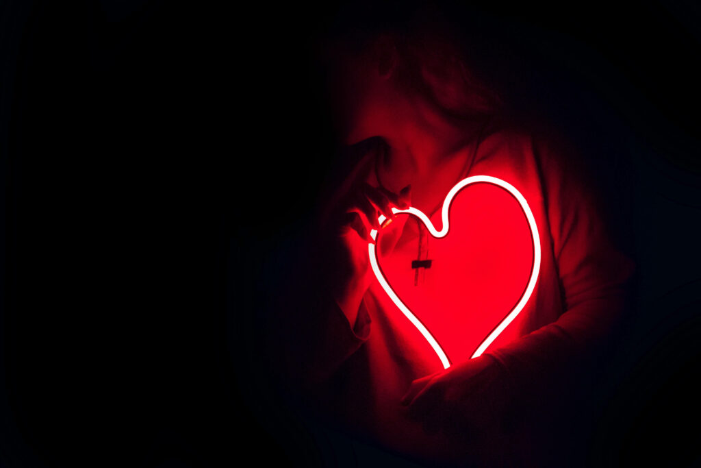 Magical Neon Red Heart Wallpaper: Romantic Glow in Dark Background