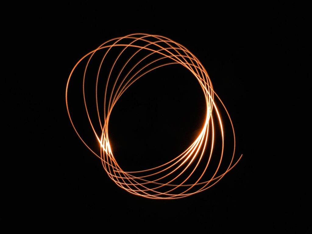 Abstract Spiral Wallpaper: Glowing Orange Lines on Black Background