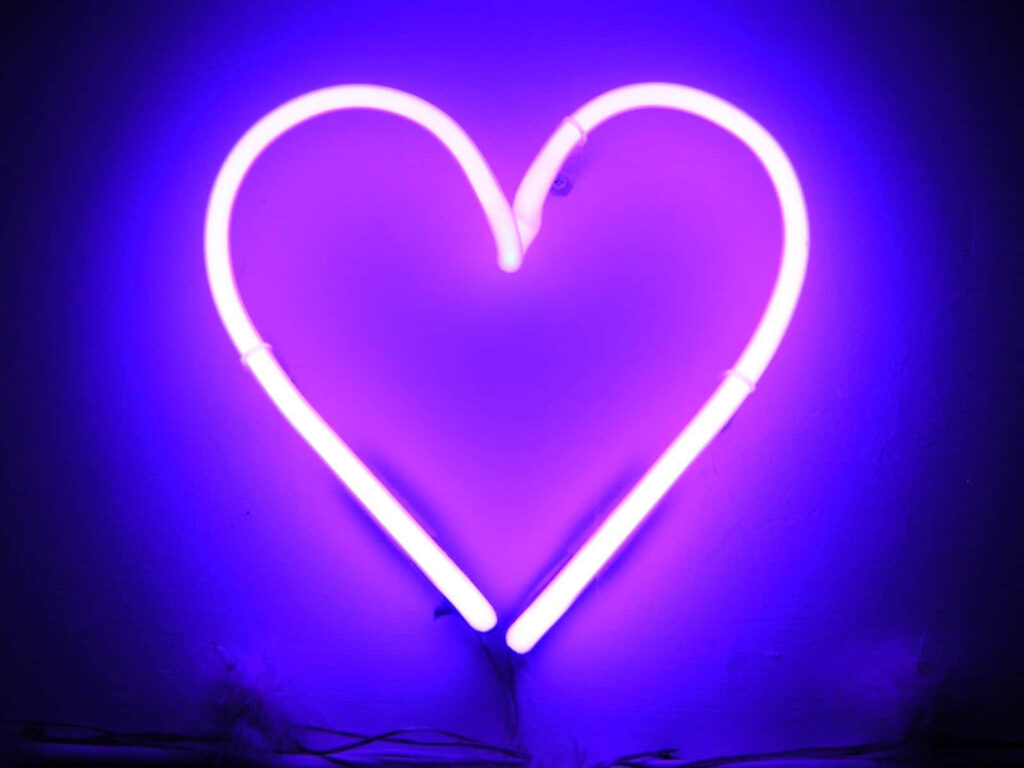 Glowing Purple Neon Heart Wallpaper on Dark Background