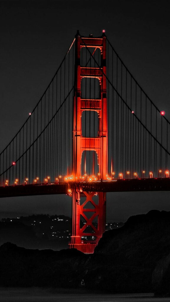 Captivating Contrasts: San Francisco's Iconic Red Bridge Shines Amidst a Dramatic Cityscape and Majestic Coastal Rocks - Breathtaking San Francisco Iphone Background Wallpaper