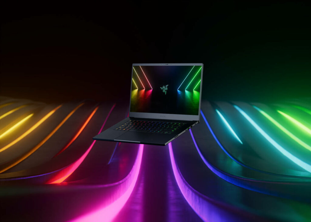 Futuristic Razer Blade Laptop Illuminated by Vibrant Neon Lights in 4k Resolution Wallpaper