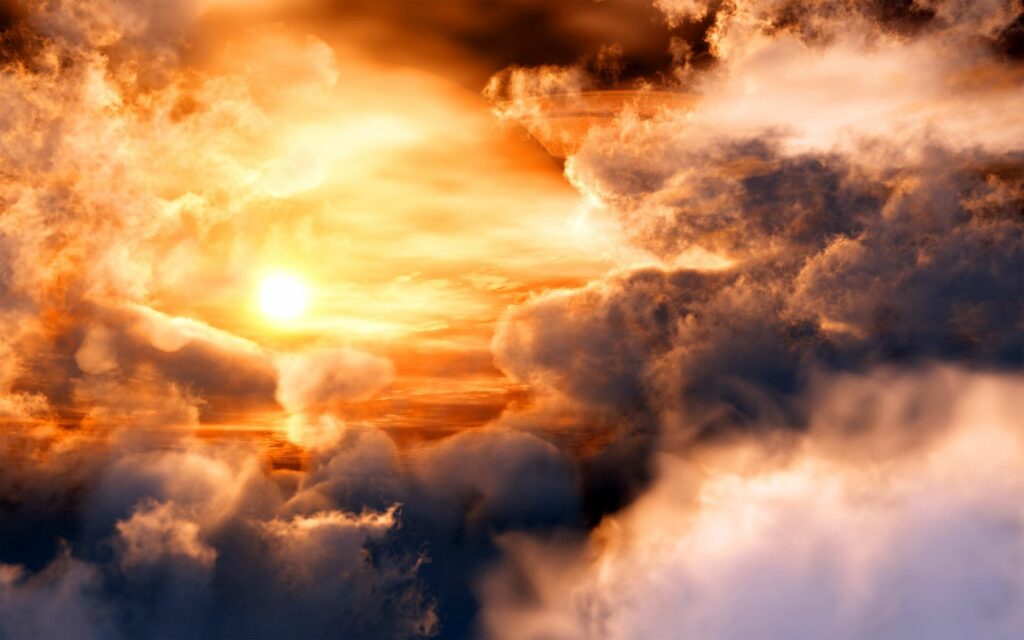 Glowing sunset with golden clouds and Saturn in sky creating dreamy cosmic wallpaper background
